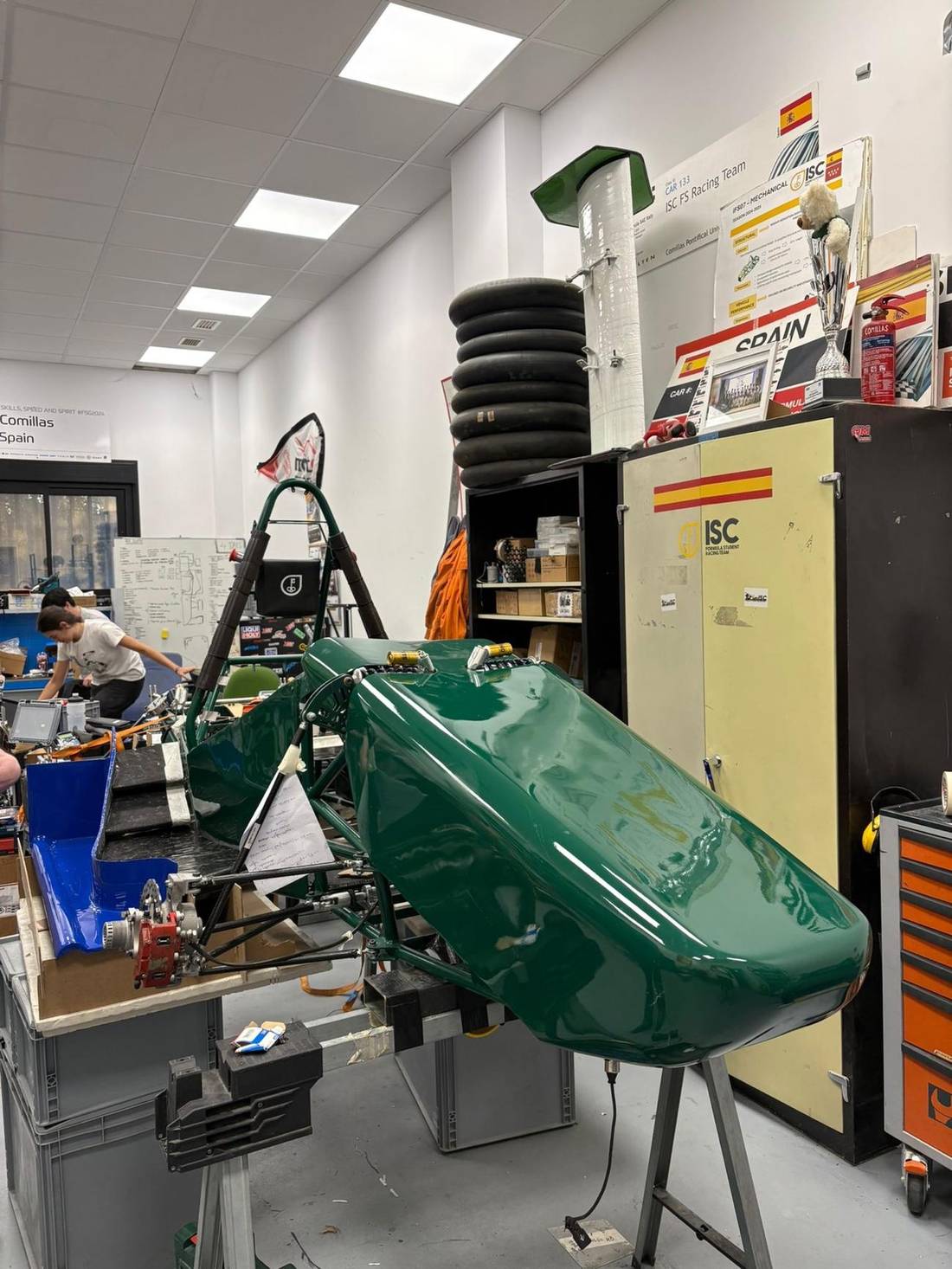 Green bodywork being fitted in the workshop